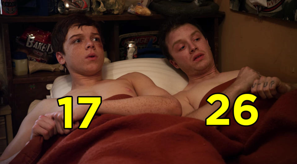 Cameron Monoghan and Noel Fisher in bed shirtless from a scene from "Shameless"