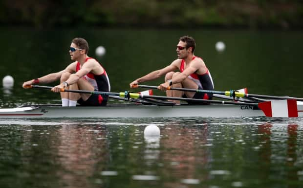 Canada's Maxwell Lattimer, left, and Patrick Keane are shown in competition at the 2021 Olympic Qualification Regatta in Lucerne, Switzerland. On Sunday, the duo qualified a boat for Canada at the Tokyo Games. (Daniel Kopatsch/Getty Images - image credit)