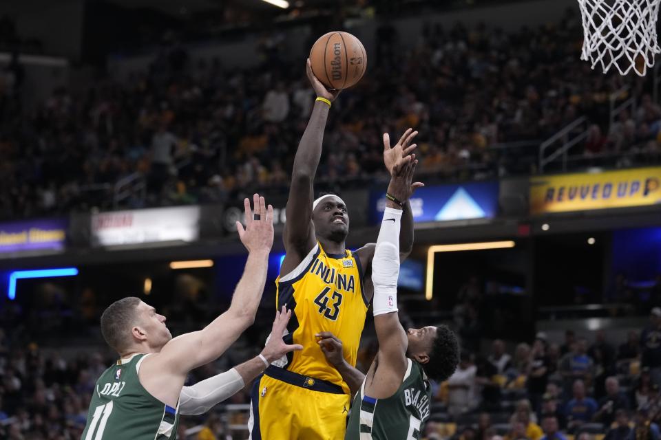Indiana Pacers' Pascal Siakam (43) shoots over Milwaukee Bucks' Brook Lopez (11) and Malik Beasley during the second half of Game 4 of the first round NBA playoff basketball series, Sunday, April 28, 2024, in Indianapolis. (AP Photo/Michael Conroy)