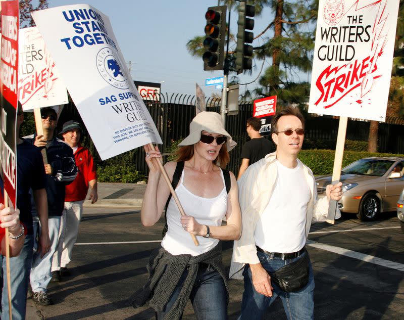 FILE PHOTO: Actress Helgenberger and a member of the Screen Actors Guild walks a picket line in Los Angeles