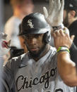 Chicago White Sox's Luis Robert is congratulated by teammates after hitting a solo home run off Cleveland Indians relief pitcher Trevor Stephan during the fifth inning of a baseball game in Cleveland, Friday, Sept. 24, 2021. (AP Photo/Phil Long)