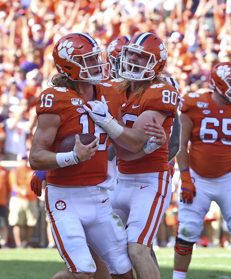 Clemson's Trevor Lawrence, left, and Luke Price celebrate Lawrence's touchdown during the first half of an NCAA college football game against Texas A&M, Saturday, Sept. 7, 2019, in Clemson, S.C. (AP Photo/Richard Shiro)