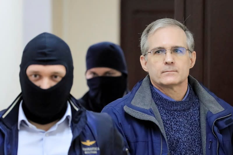 FILE PHOTO: Former U.S. Marine Paul Whelan, who was detained and accused of espionage, is escorted inside a court building in Moscow