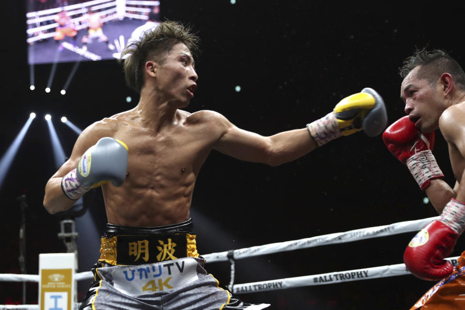 Japan's Naoya Inoue, left, sends a left to Philippines' Nonito Donaire in the sixth round of their World Boxing Super Series bantamweight final match in Saitama, Japan, Thursday, Nov. 7, 2019. Inoue beat Donaire with a unanimous decision to win the championship. (AP Photo/Toru Takahashi)