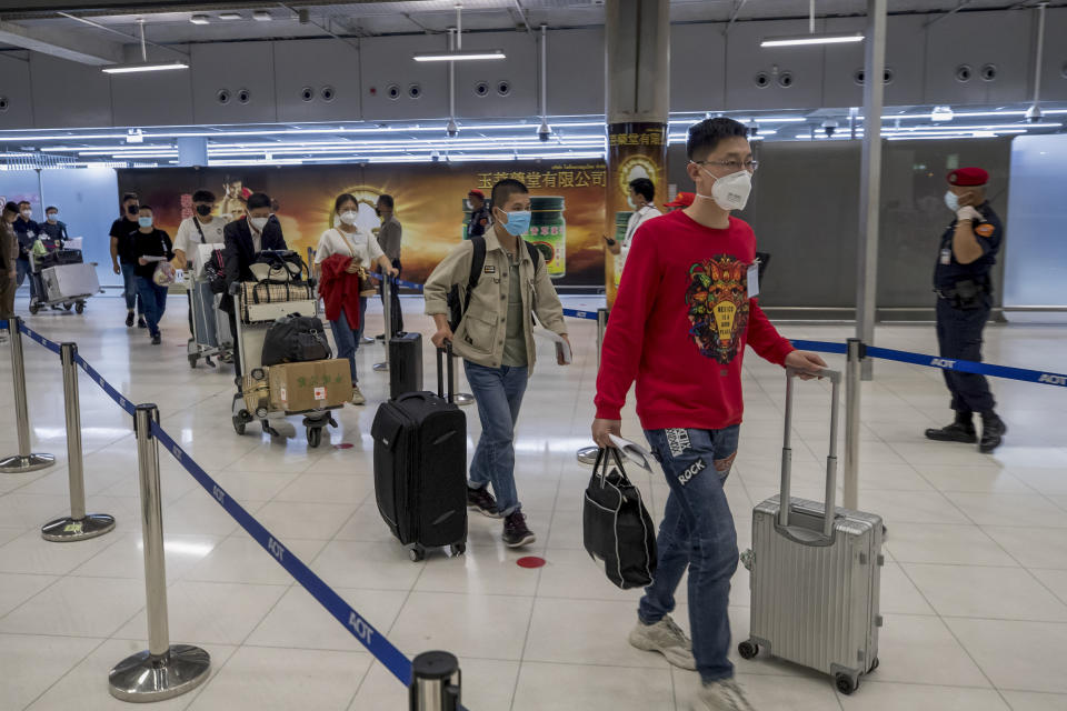 Chinese tourists from Shanghai arrive at Suvarnabhumi airport on special tourist visas, in Bangkok, Thailand, Tuesday, Oct. 20, 2020. Thailand on Tuesday took a modest step toward reviving its coronavirus-battered tourist industry by welcoming 39 visitors who flew in from Shanghai, the first such arrival since normal traveler arrivals were banned almost seven months ago. (AP Photo/Wason Wanichakorn)