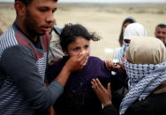 <p>A Palestinian girl reacts to tear gas fired by Israeli troops near the Israel-Gaza border during a tent city protest demanding the right to return to their homeland, east of Gaza City, April 3, 2018. (Mohammed Salem/Reuters) </p>