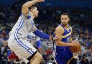 Jan 22, 2017; Orlando, FL, USA; Golden State Warriors guard Stephen Curry (30) moves to the basket s Orlando Magic center Nikola Vucevic (9) defends during the first quarter at Amway Center. Mandatory Credit: Kim Klement-USA TODAY Sports