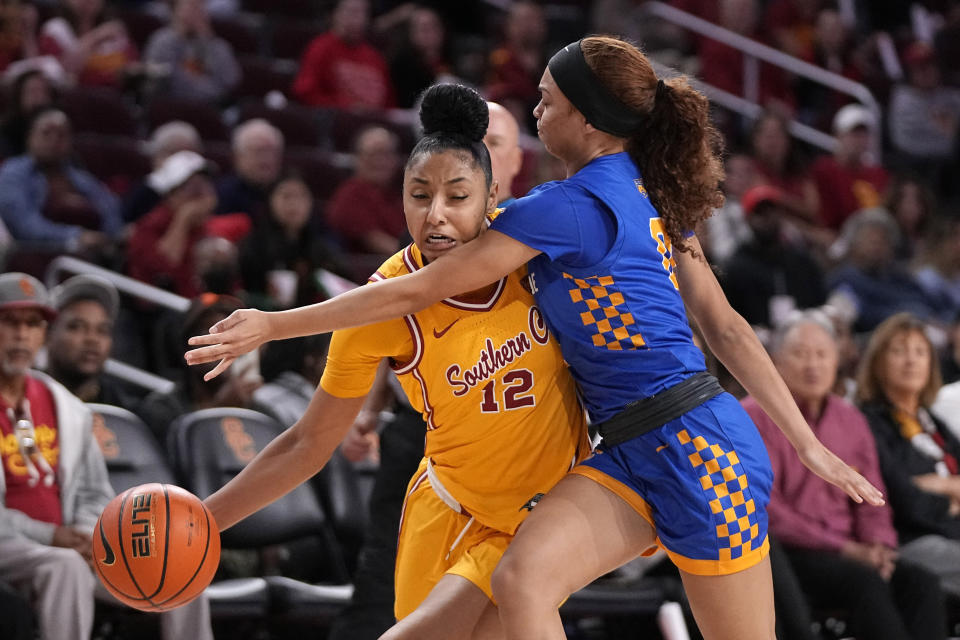 Southern California guard JuJu Watkins, left, tries to get by UC Riverside guard Makayla Jackson during the first half of an NCAA college basketball game Sunday, Dec. 10, 2023, in Los Angeles. (AP Photo/Mark J. Terrill)