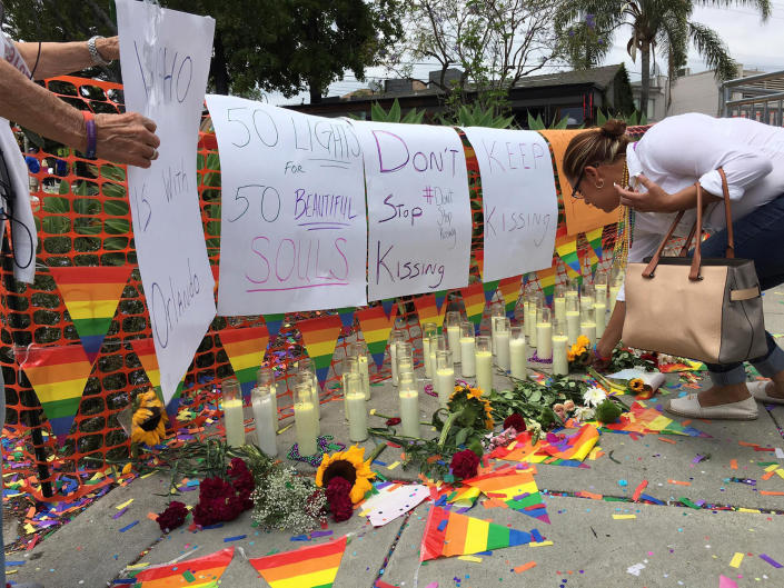 <p>People tend to a memorial at the Christopher Street West presentation of the Los Angeles LGBT Pride Parade in West Hollywood, Calif., June 12, 2016 in honor of the victims of the deadly attacks at a gay night club in Orlando, Florida earlier in the morning. (REUTERS/Lisa Richwine) </p>