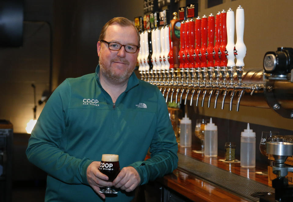 Sean Mossman, director of sales and marketing for COOP Ale Works, poses for a photo in the COOP taproom in Oklahoma City, Friday, Jan. 18, 2019. Rules that went into effect in Oklahoma in October allow grocery, convenience and retail liquor stores to sell chilled beer with an alcohol content of up to 8.99 percent. Previously, grocery and convenience stores could offer only 3.2 percent beer. Liquor stores, where stronger beers were available, were prohibited from selling it cold. (AP Photo/Sue Ogrocki)