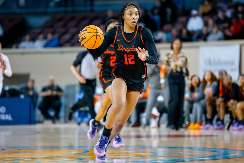 Douglass’ N’kiyah Burge (12) works up court during the semifinals of the girls state basketball tournament between Bethany and Douglass at the Jim Norick Arena in Oklahoma City, on Friday, March 8, 2024.