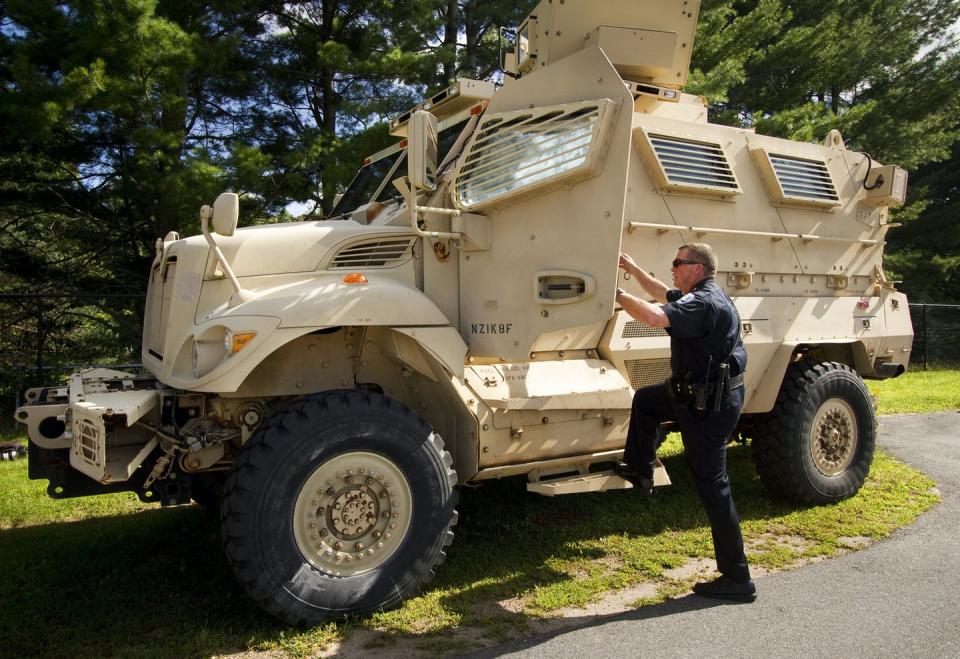 <span class="caption">The police chief of Sanford, Maine, population 21,000, climbs into his department’s mine-resistant ambush protected vehicle, one of five in the state obtained from military surplus.</span> <span class="attribution"><a class="link " href="https://www.gettyimages.com/detail/news-photo/sanford-police-chief-thomas-connolly-steps-into-the-news-photo/454140118" rel="nofollow noopener" target="_blank" data-ylk="slk:Carl D. Walsh/Portland Press Herald via Getty Images;elm:context_link;itc:0;sec:content-canvas">Carl D. Walsh/Portland Press Herald via Getty Images</a></span>