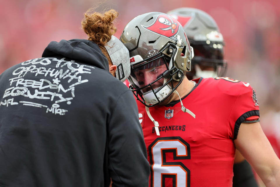 Baker Mayfield of the Tampa Bay Buccaneers, right, bumps heads with Ryan Jensen. (Photo by Mike Carlson/Getty Images)