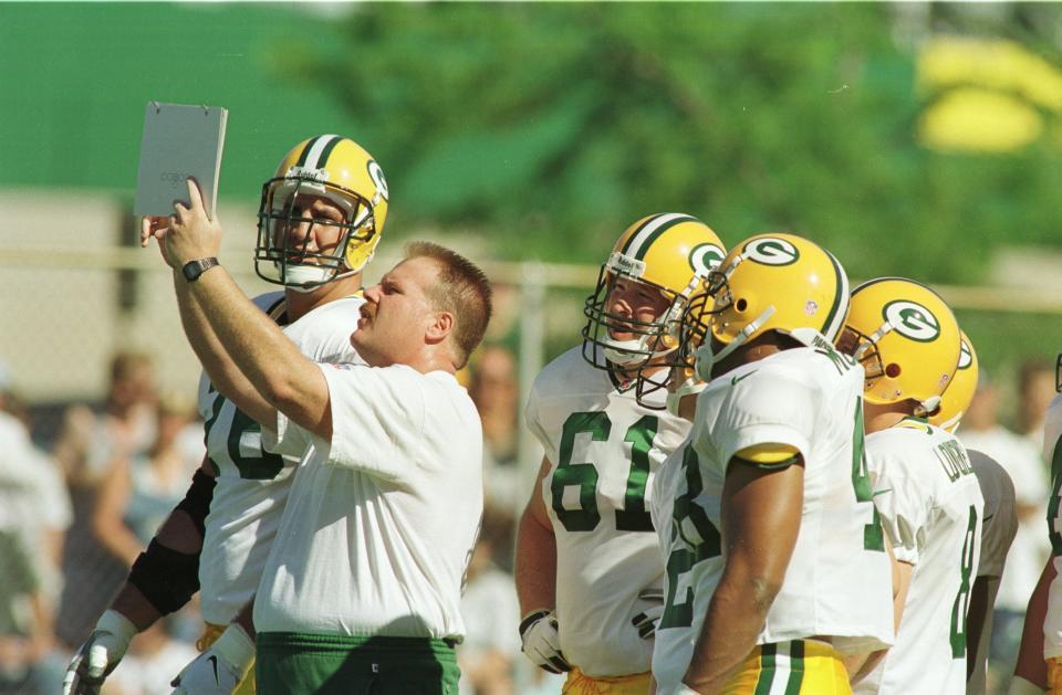 Andy Reid works with players during the Green Bay Packers first practice of 1998 season.