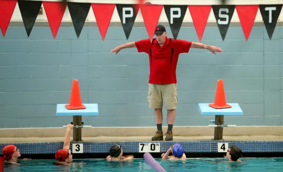 Poulsbo Piranhas Swim Team coach Ron Allen gives instructions from the pool deck during practice at the NK Community Pool on Wednesday, July 12, 2023.