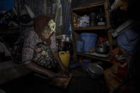 Mother of two Amsale Hailemariam, a domestic worker who lost work because of the coronavirus, prepares food for her family in her small tent in the capital Addis Ababa, Ethiopia on Friday, June 26, 2020. The better-off neighbors who once welcomed her into their homes to cook and clean now turn her away, fearing the virus. “They told me we should avoid contact,” she said. “There was no help I received from them since.” (AP Photo/Mulugeta Ayene)