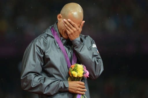 Dominican Republic's gold medalist Felix Sanchez cries on the podium of the men's 400m hurdles at the athletics event of the London 2012 Olympic Games on August 6, 2012 in London