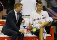 Tennis - Great Britain v United States of America - Davis Cup World Group First Round - Emirates Arena, Glasgow, Scotland - 6/3/15 USA's John Isner looks dejected as he sits with USA captain Jim Courier (L) during a break in between games Action Images via Reuters / Andrew Boyers Livepic