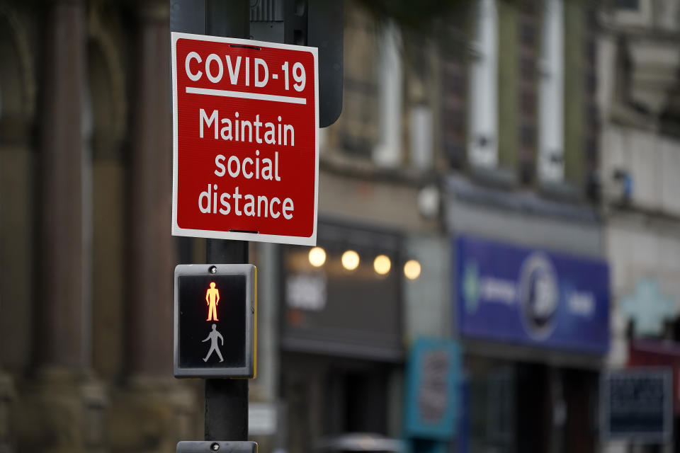 LIVERPOOL, ENGLAND - OCTOBER 08: A social distancing sign is affixed next to a pedestrian crossing on October 08, 2020 in Liverpool, England. It has been reported that a three-tier lockdown system, similar to a traffic light system is being contemplated by the British government to simplify coronavirus (Covid-19) lockdown measures. (Photo by Christopher Furlong/Getty Images)