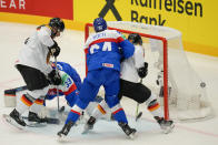 Germany's Dominik Kahun, right, scores his side's opening goal during the preliminary round match between Slovakia and Germany at the Ice Hockey World Championships in Ostrava, Czech Republic, Friday, May 10, 2024. (AP Photo/Darko Vojinovic)