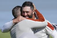 Team Europe's Sergio Garcia and Team Europe's Jon Rahm celebrate after winning their foursomes match the Ryder Cup at the Whistling Straits Golf Course Saturday, Sept. 25, 2021, in Sheboygan, Wis. (AP Photo/Ashley Landis)