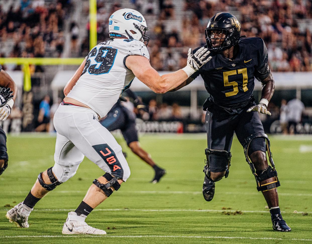 Redshirt sophomore defensive end Malachi Lawrence (51) battles with tackle Paul Rubelt during UCF's spring football game.