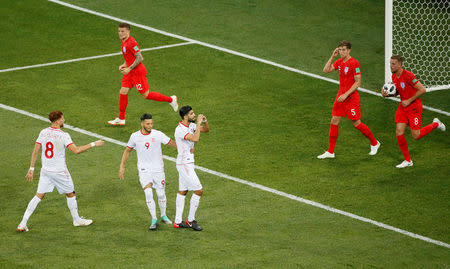 Soccer Football - World Cup - Group G - Tunisia vs England - Volgograd Arena, Volgograd, Russia - June 18, 2018 Tunisia's Ferjani Sassi celebrates scoring their first goal as England's Jordan Henderson, John Stones and Kieran Trippier react REUTERS/Gleb Garanich