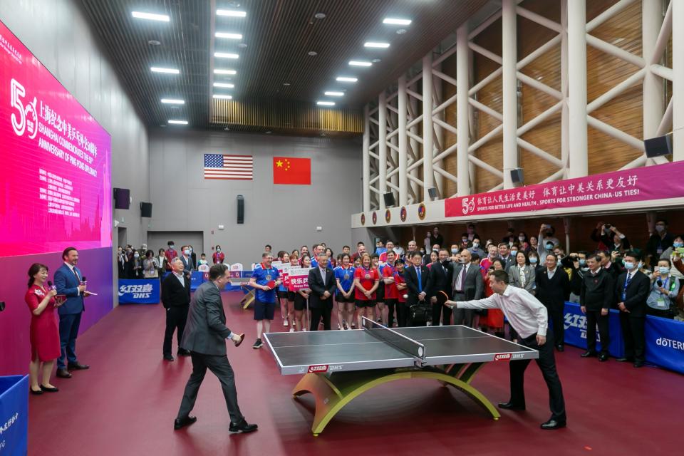 SHANGHAI, April 10, 2021 -- Vice president of the International Table Tennis Federation Shi Zhihao (R, front) and the U.S. Consul General in Shanghai James Heller (L, front) play the first shot for a China-U.S. Ping-Pong friendly match during a special event to commemorate the 50th anniversary of the Ping-Pong Diplomacy between China and the United States in Shanghai, east China, April 10, 2021. (Photo by Wang Xiang/Xinhua via Getty) (Xinhua/Wang Xiang via Getty Images)