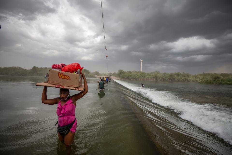 Haitian migrants cross the Rio Grande as they hope to enter the U.S. via Del Rio, Texas from Ciudad Acuna, Mexico.