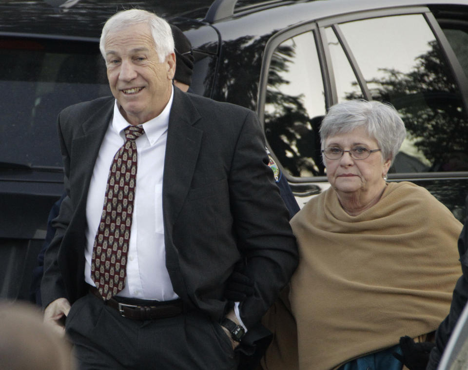 FILE - In this Dec. 13, 2011 file photo, former Penn State assistant football coach Jerry Sandusky arrives with his wife, Dottie Sandusky, for a preliminary hearing at the Centre County Courthouse in Bellefonte, Pa. Dottie Sandusky says it was long after he’d been arrested, tried and convicted before she realized just how much trouble the former Penn State assistant football coach had gotten himself into. In an interview this week at her home in State College, Dottie Sandusky said that even after his 45-count guilty verdict in the child molestation case, she still had had hope. But when the judge gave him to 30 to 60 years in state prison, she said, she fully comprehended the trouble he was in. She’s been granting interviews in recent weeks, arguing her husband’s conviction was unjust and claiming the victims who testified against him told inaccurate stories to cash in. An attorney involved in negotiating with Penn State on behalf of his victims calls her denials “obscene.” (AP Photo/Gene J. Puskar, File)