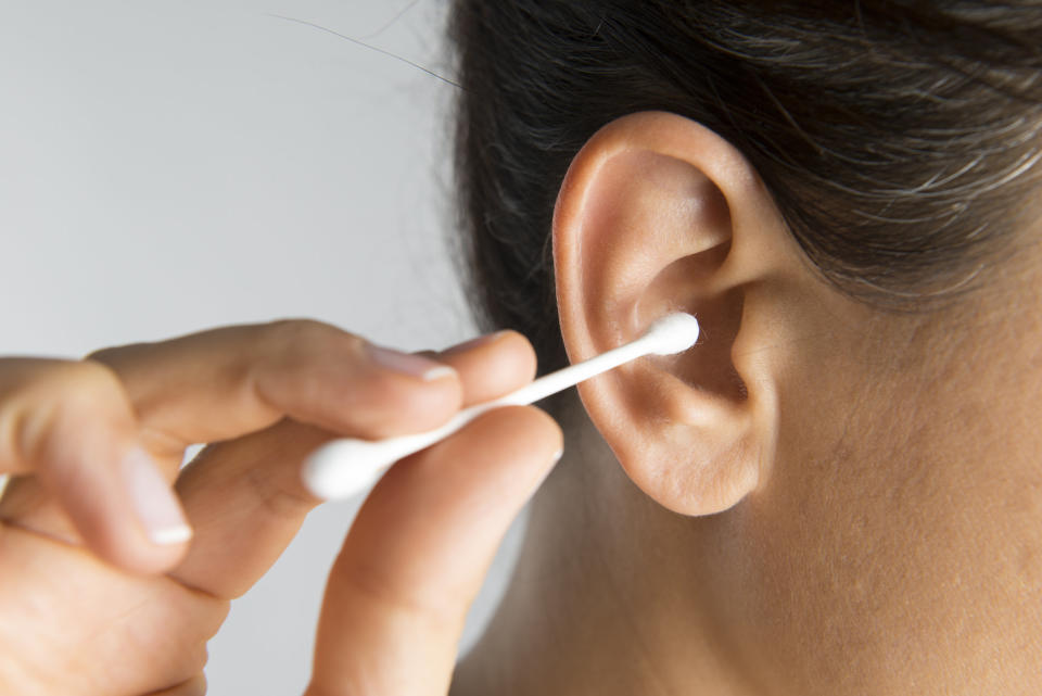 A person cleaning out their ear