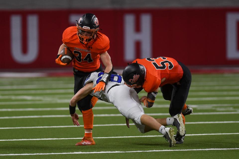 Dell Rapids' running back Mason Stubbe (34) gets tackled by West Central's defense back Aiden Bartmann (20) on Friday, Nov 10, 2023 at DakotaDome in Vermillion, South Dakota.