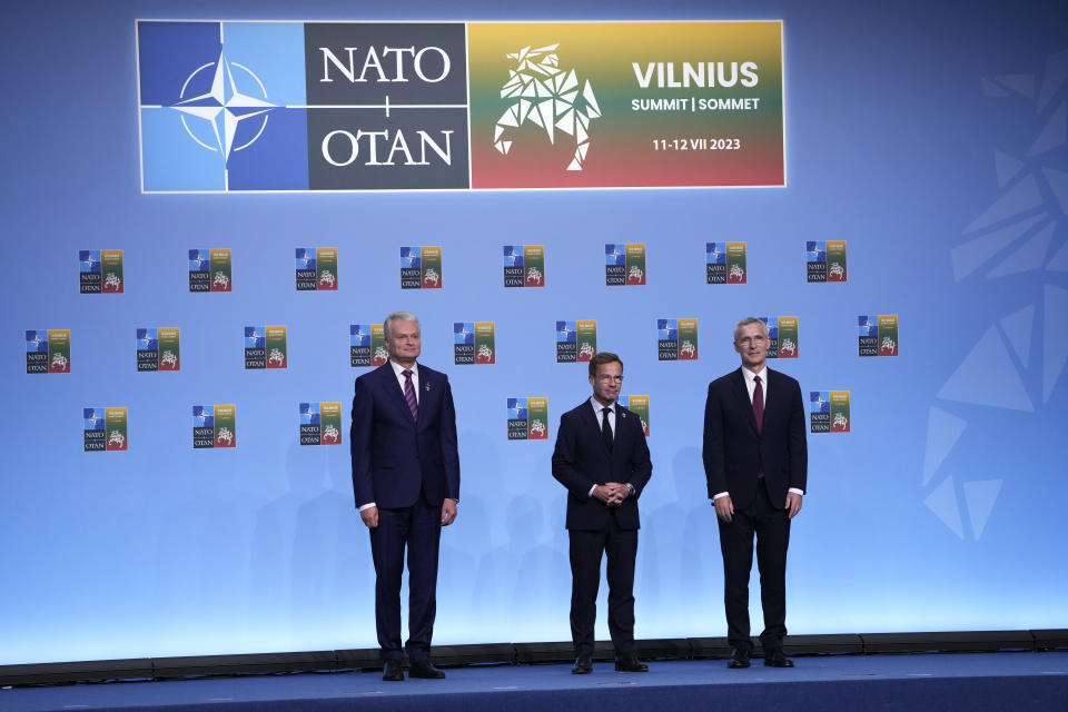 NATO Secretary General Jens Stoltenberg, right, Sweden's Prime Minister Ulf Kristersson, center, and Lithuania's President Gitanas Nauseda, left, pose during arrivals for the family photo at the NATO summit in Vilnius, Lithuania, Tuesday, July 11, 2023. (AP Photo/Susan Walsh, Pool)