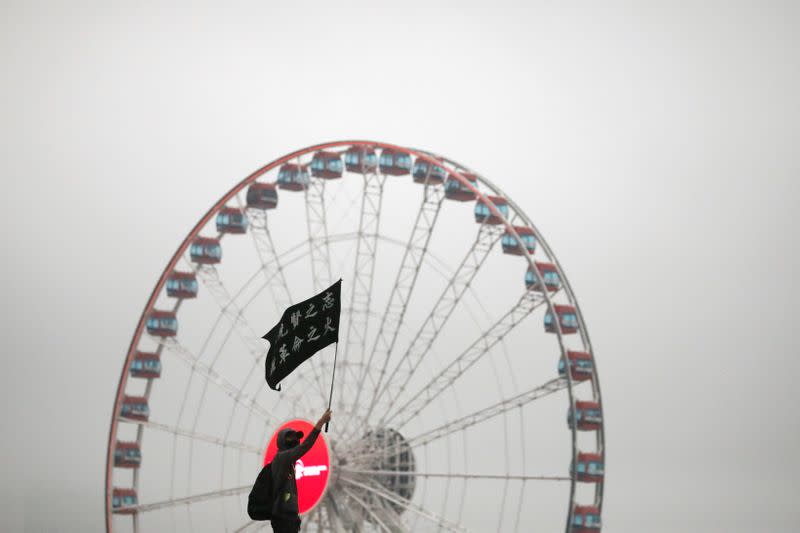 An anti government protester waves a flag during a rally at Edinburgh Place in Hong Kong