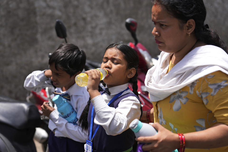 A schoolgirl takes a drink on a hot summer day in Lucknow, India, Friday, May 3, 2024. (AP Photo/Rajesh Kumar Singh)