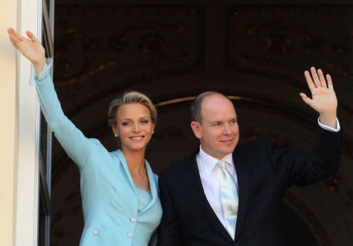 Prince Albert II and Princess Charlene of Monaco greet well-wishers from the balcony after their civil wedding at the Prince's Palace