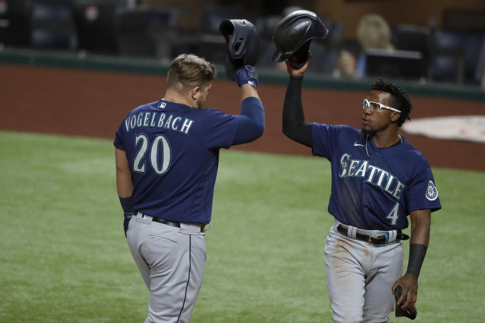 Seattle Mariners' Daniel Vogelbach (20) and Shed Long Jr. (4) celebrate a two-run home run by Vogelbach that scored Long Jr., in the second inning of a baseball game against the Texas Rangers in Arlington, Texas, Wednesday, Aug. 12, 2020. (AP Photo/Tony Gutierrez)