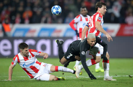 Soccer Football - Champions League - Group Stage - Group C - Crvena Zvezda v Paris St Germain - Rajko Mitic Stadium, Belgrade, Serbia - December 11, 2018 Paris St Germain's Kylian Mbappe in action with Crvena Zvezda's Milos Degenek and Filip Stojkovic REUTERS/Marko Djurica