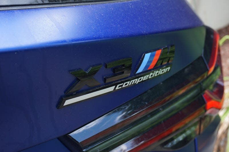 A photo of a blue 2022 BMW X3 M Competition.
