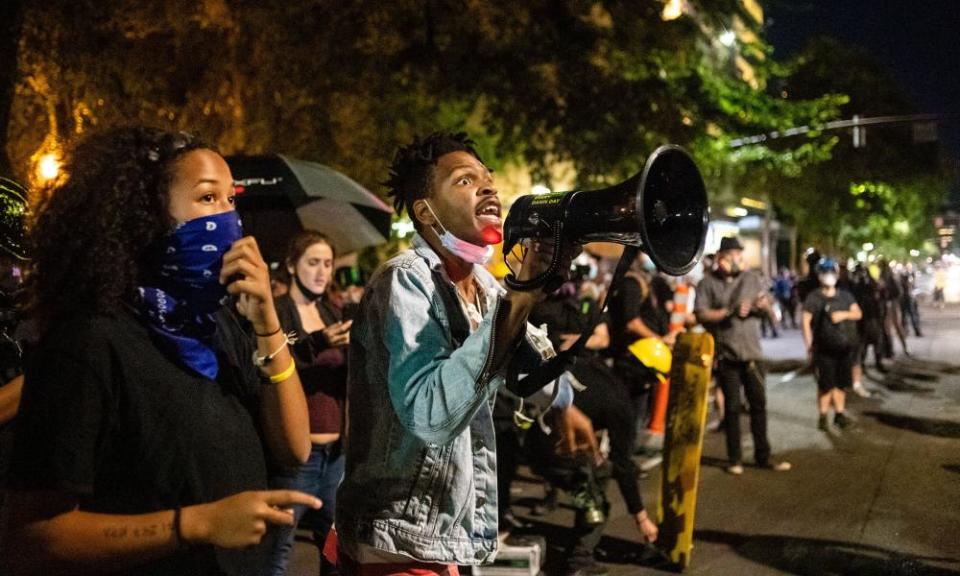 Najee Gow, an organiser for Black Lives Matter, gathers with other protesters at the courthouse.