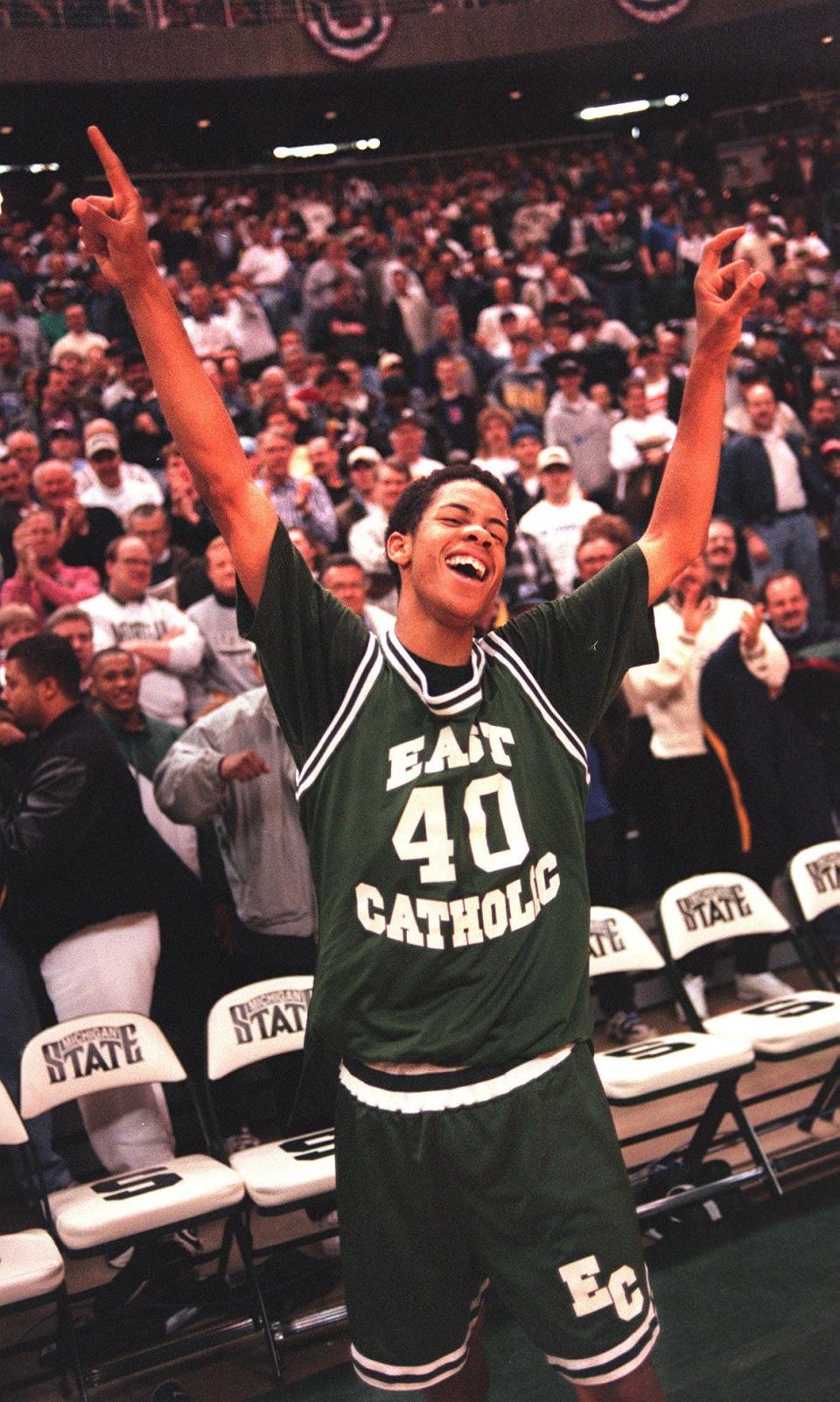 Detroit East Catholic's Andrew Mitchell celebrates after scoring the winning bucket with seconds left in the 1997 Class D finals against Wyoming Tri-Unity Christian.