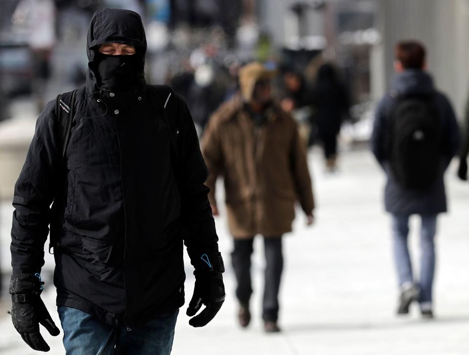 A man is bundled up against Chicago's cold, in downtown Chicago, Sunday, Jan. 27, 2019.