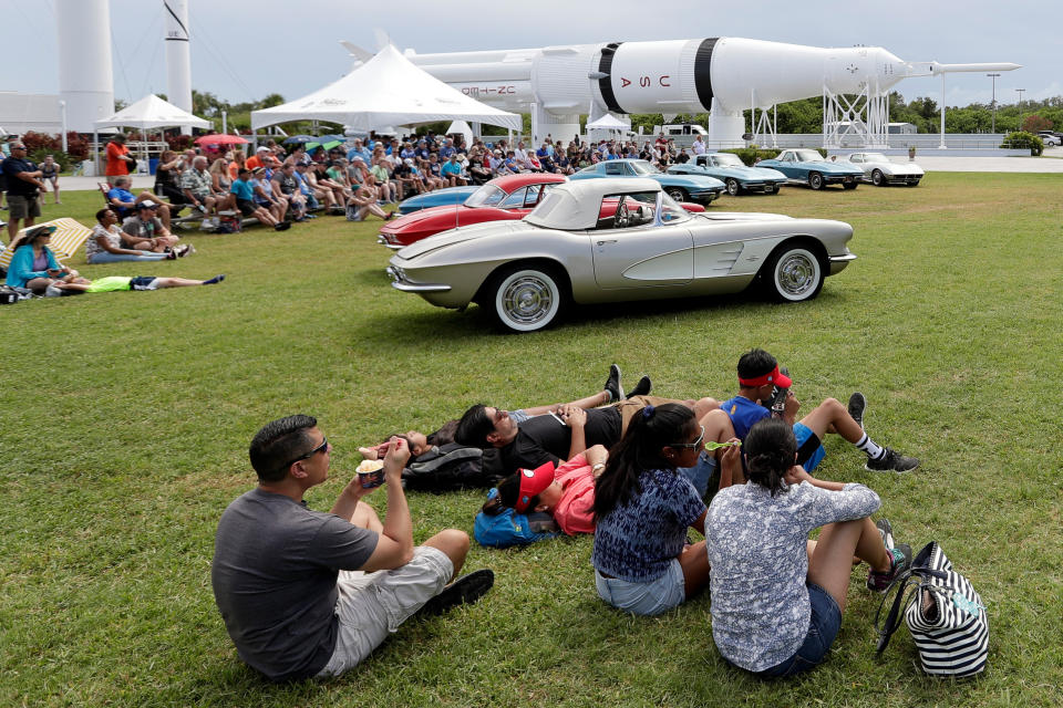 Guests watch a video and commentary about the moon landing at the Kennedy Space Center Visitor Complex during the Apollo 11 anniversary, Saturday, July 20, 2019, in Cape Canaveral, Fla. (AP Photo/John Raoux)