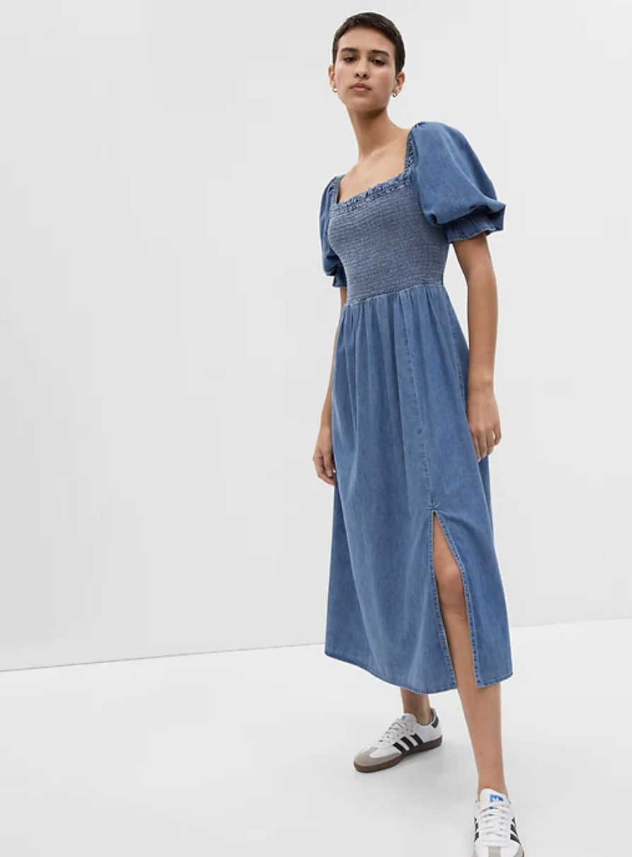 model with short hair wearing sneakers and blue Puff Sleeve Denim Midi Dress with Washwell (photo via Gap)