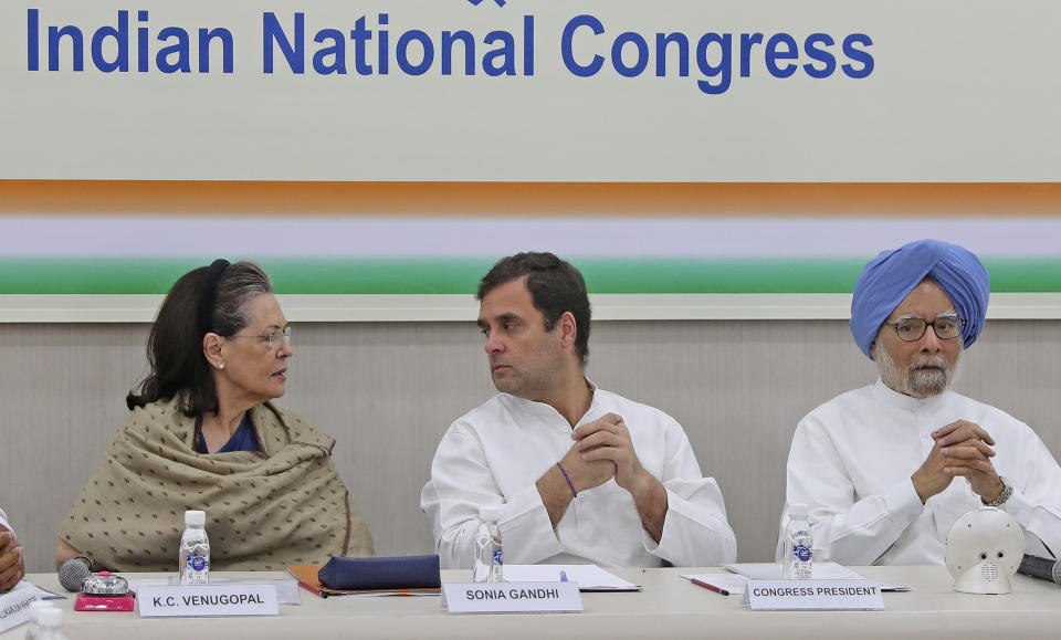 FILE- In this Saturday, May 25, 2019, file photo, Congress party leader Sonia Gandhi, left, her son and party President Rahul Gandhi, center, and former Indian Prime Minister Manmohan Singh attend a Congress Working Committee meeting in New Delhi, India. India's main opposition Congress party appears to be drifting rudderless as it faces a crucial political test in two key state elections later in October, after a severe drubbing at the hands of Prime Minister Narendra Modi’s Hindu nationalist party in the May national elections. (AP Photo/Altaf Qadri)