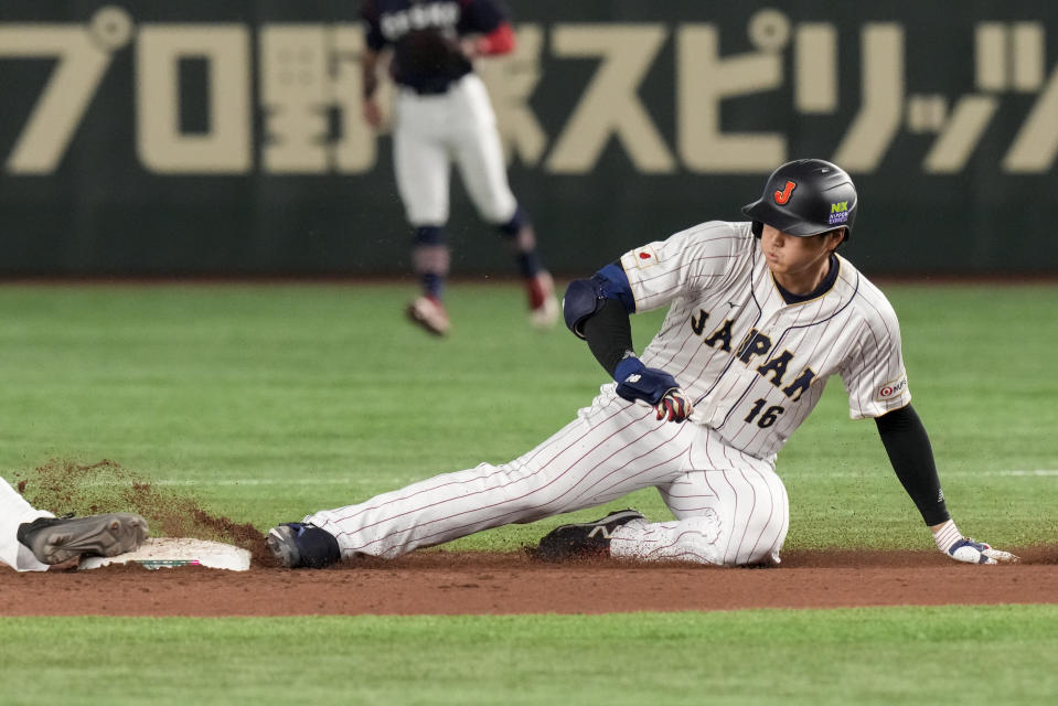 Shohei Ohtani of Japan slides into second base during their Pool B game against the Czech Republic at the World Baseball Classic at the Tokyo Dome, Japan, Saturday, March 11, 2023. (AP Photo/Eugene Hoshiko)