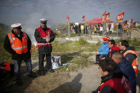 CGT labour union employees of French state-owned railway company SNCF gather near a barricade to block the entrance of the depot of the SFDM company near the oil refinery of Donges, France, May 25, 2016. in protest over proposed new labour laws. REUTERS/Stephane Mahe