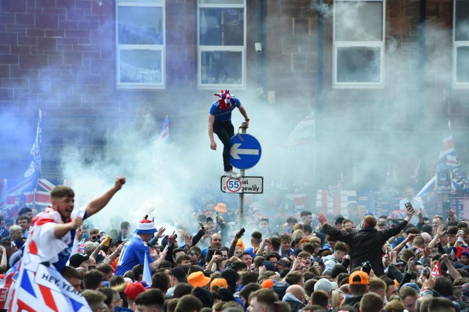 Rangers fans celebrate outside Ibrox Stadium after the team lifted the Scottish Premiership trophy for the first time in 10 years