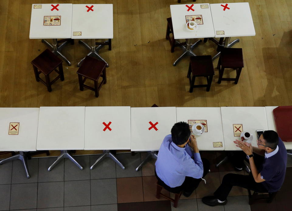 Diners keep their social distance at a cafe during the coronavirus disease (COVID-19) outbreak in Singapore September 7, 2021. REUTERS/Edgar Su