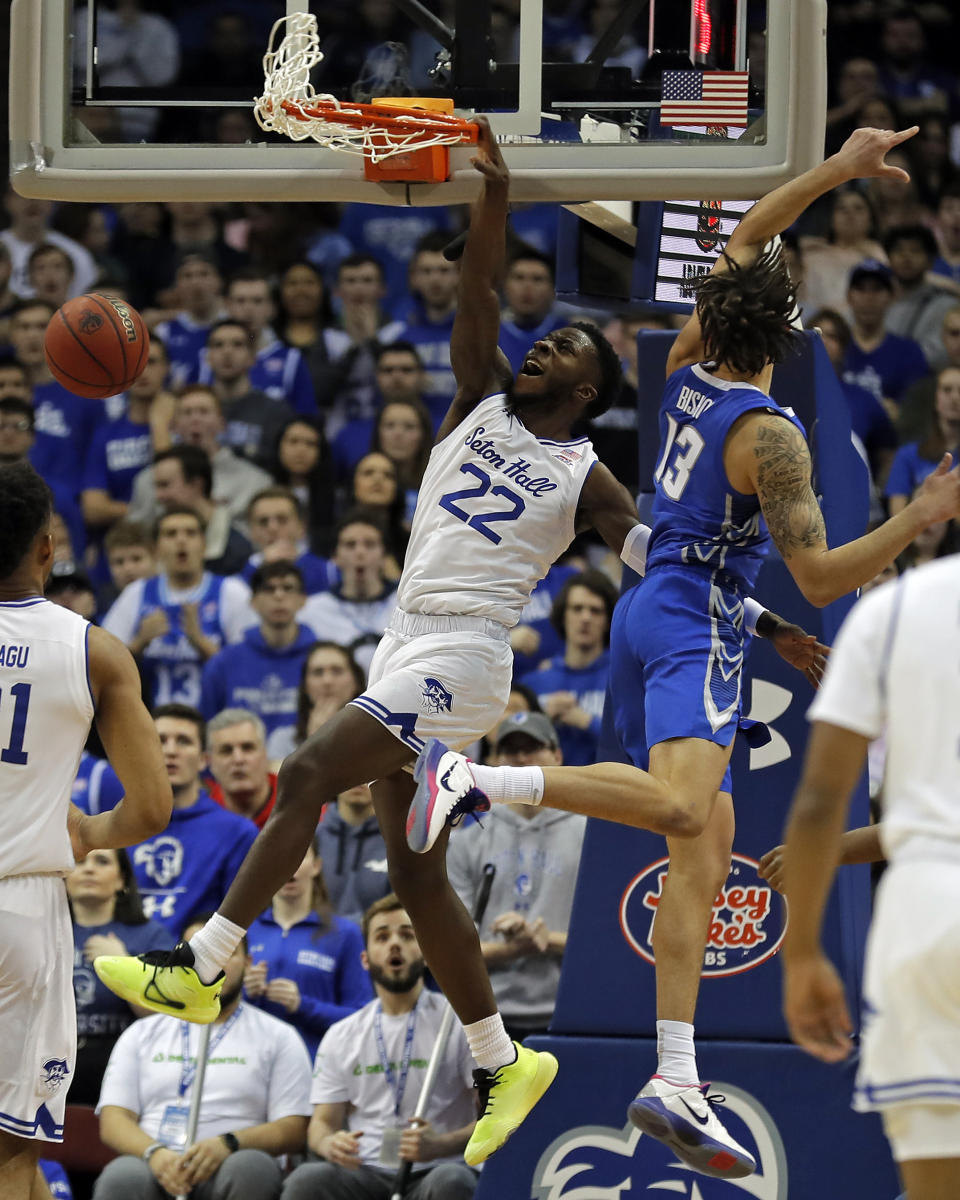 Seton Hall guard Myles Cale (22) slam dunks the ball past Creighton forward Christian Bishop (13) during the first half of an NCAA college basketball game Wednesday, Feb. 12, 2020, in Newark, N.J.. (AP Photo/Adam Hunger)